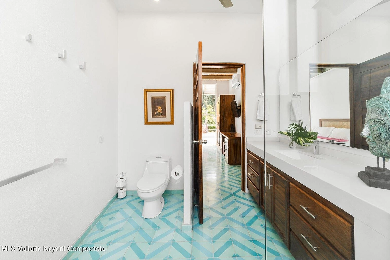 Modern bathroom at Casa Palmazul in Sayulita with sleek fixtures, a large mirror, bright lighting, and clean, elegant design with tropical accents.