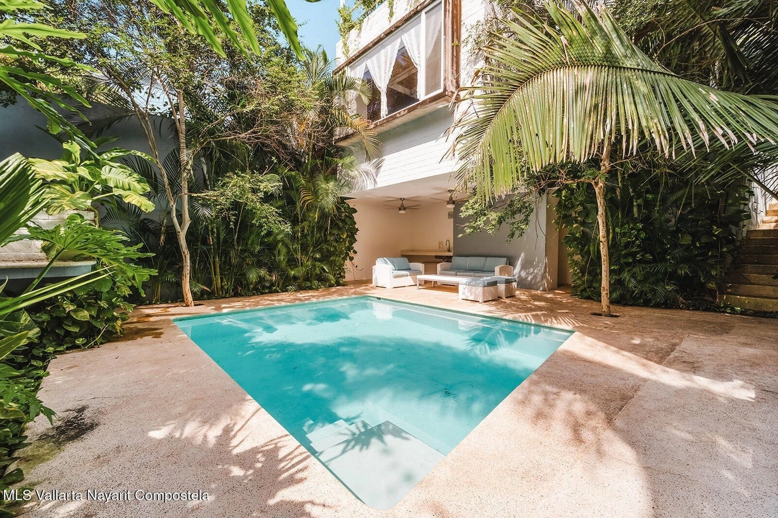 Relaxing pool area with jungle views at Casa Palmazul, house for sale in Sayulita Nayarit.