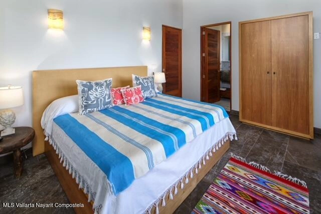 Guest bedroom with balcony and tropical views in Casa Las Hijas