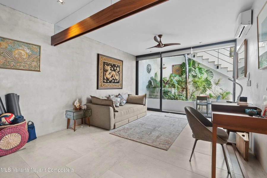 Open-concept living and dining area with natural light and ocean backdrop