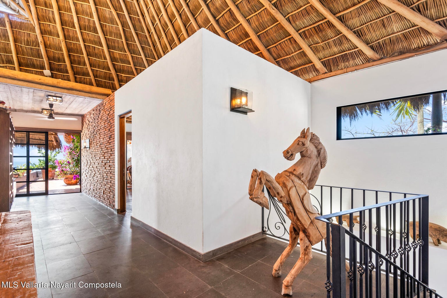 Luxury ocean view home for sale in Nanzal Hill, Sayulita featuring panoramic Pacific Ocean views, tropical landscaping, saltwater pool, rooftop terrace, gourmet kitchen, and elegant indoor-outdoor coastal living in Riviera Nayarit.