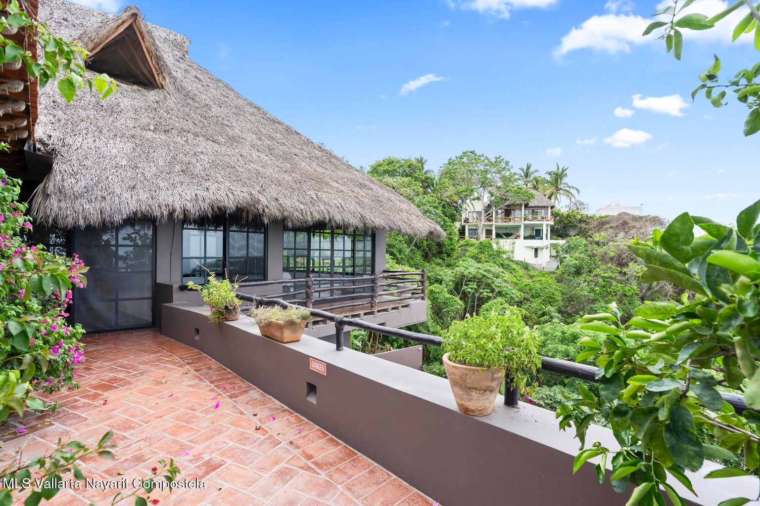 Luxury ocean view home for sale in Nanzal Hill, Sayulita featuring panoramic Pacific Ocean views, tropical landscaping, saltwater pool, rooftop terrace, gourmet kitchen, and elegant indoor-outdoor coastal living in Riviera Nayarit.