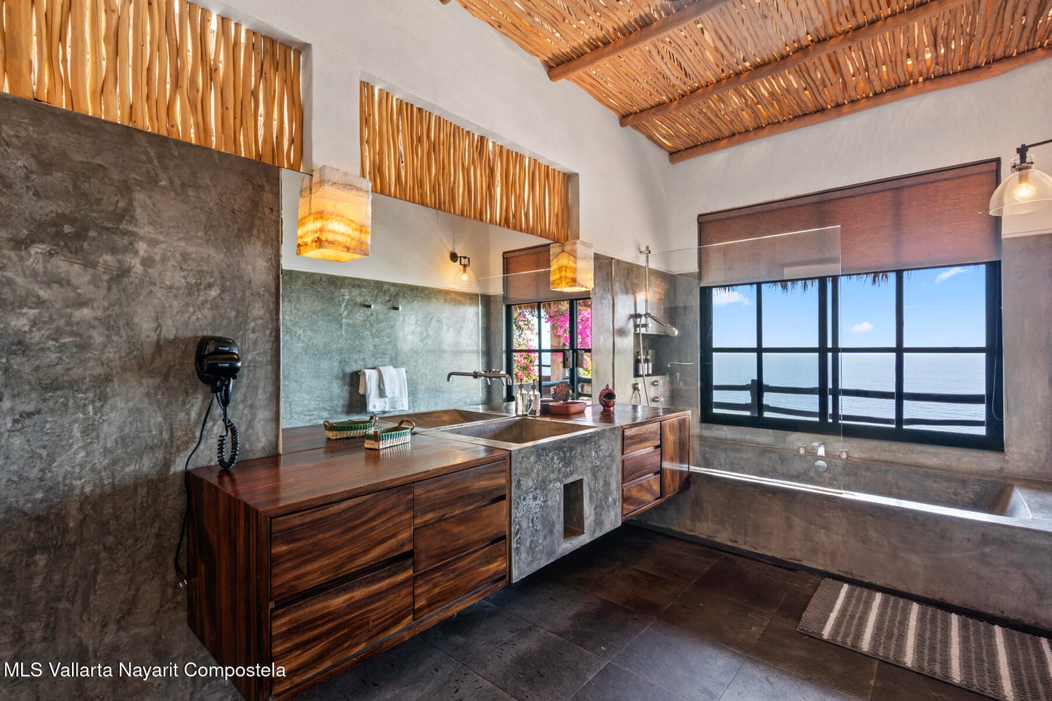 Luxury ocean view home for sale in Nanzal Hill, Sayulita featuring panoramic Pacific Ocean views, tropical landscaping, saltwater pool, rooftop terrace, gourmet kitchen, and elegant indoor-outdoor coastal living in Riviera Nayarit.