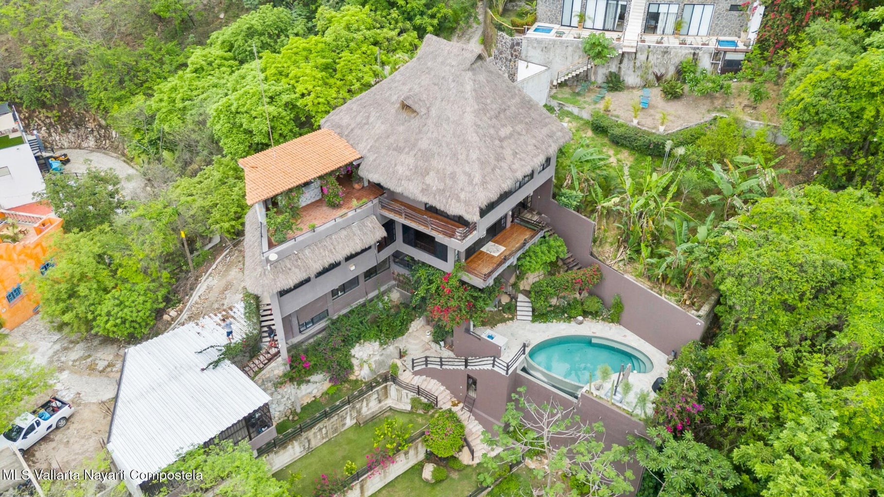 Luxury ocean view home for sale in Nanzal Hill, Sayulita featuring panoramic Pacific Ocean views, tropical landscaping, saltwater pool, rooftop terrace, gourmet kitchen, and elegant indoor-outdoor coastal living in Riviera Nayarit.
