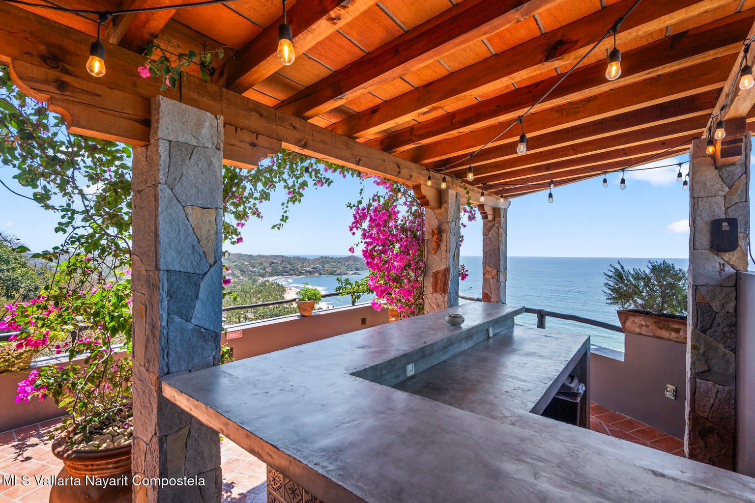 Luxury ocean view home for sale in Nanzal Hill, Sayulita featuring panoramic Pacific Ocean views, tropical landscaping, saltwater pool, rooftop terrace, gourmet kitchen, and elegant indoor-outdoor coastal living in Riviera Nayarit.
