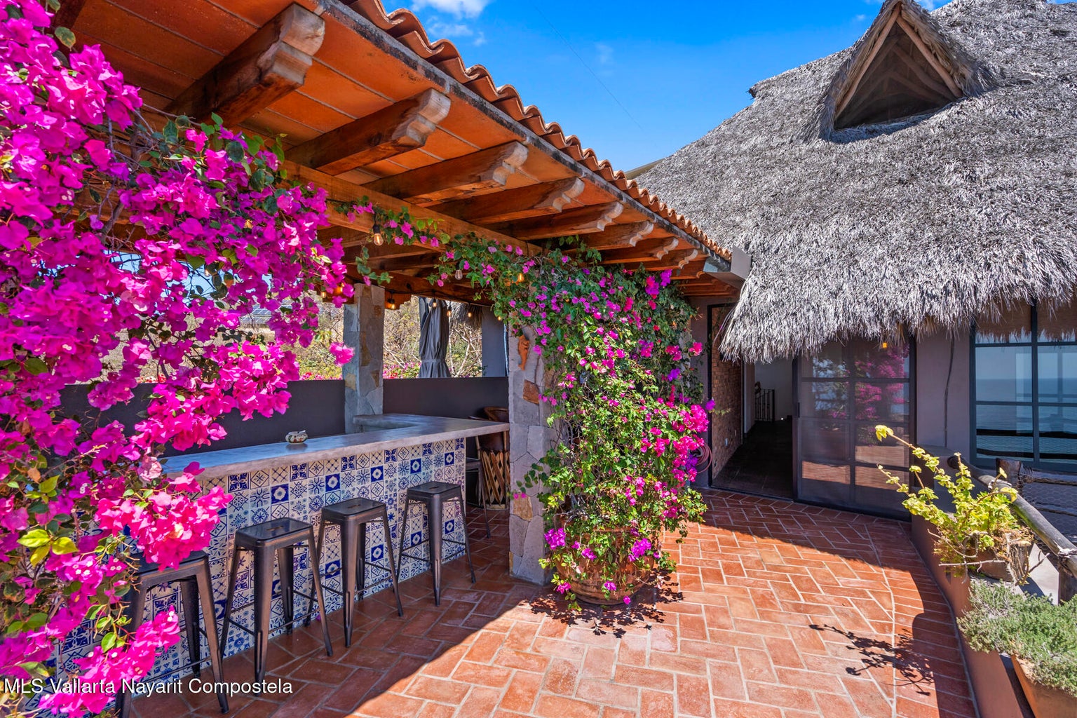 Luxury ocean view home for sale in Nanzal Hill, Sayulita featuring panoramic Pacific Ocean views, tropical landscaping, saltwater pool, rooftop terrace, gourmet kitchen, and elegant indoor-outdoor coastal living in Riviera Nayarit.