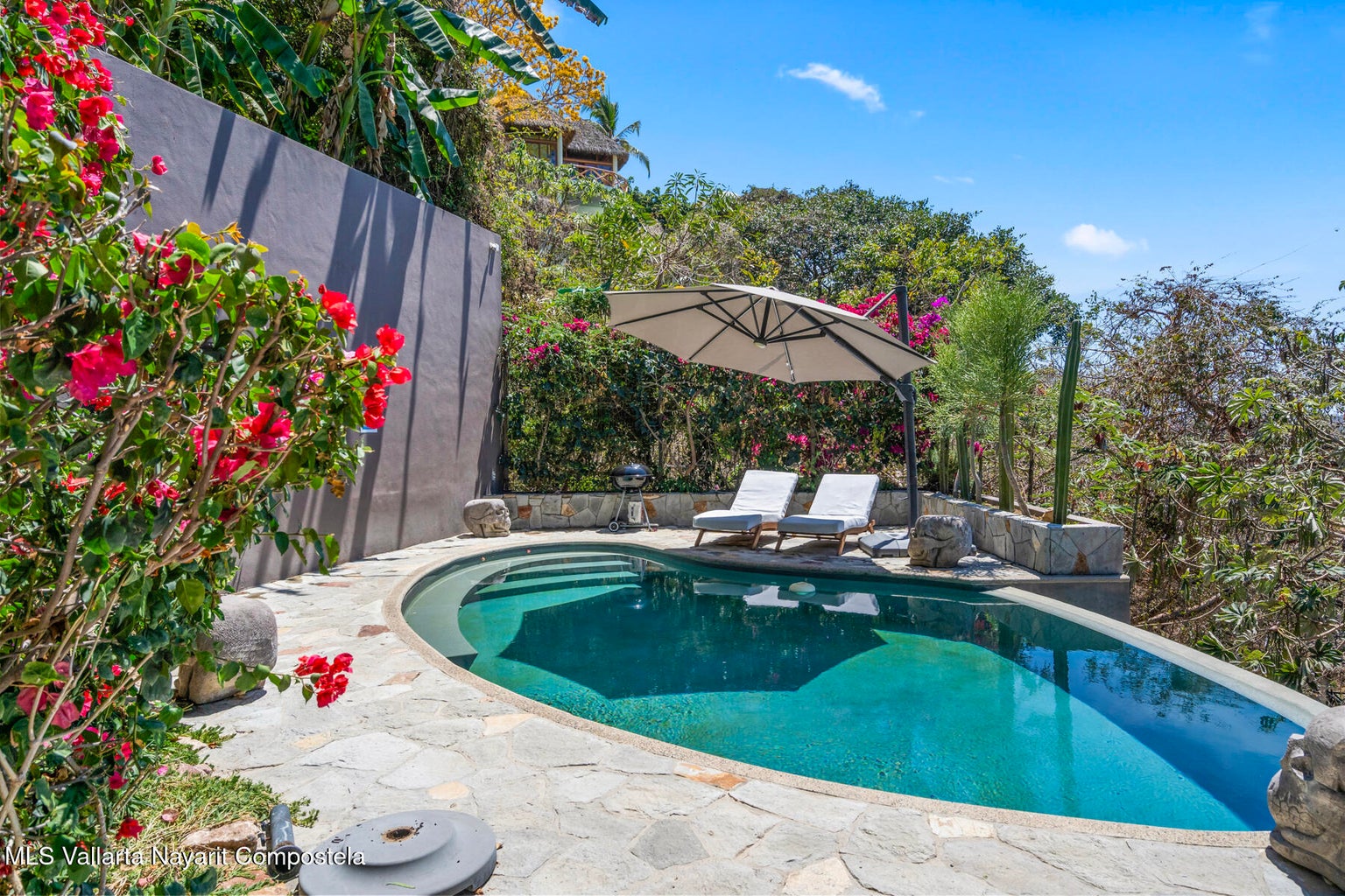 Luxury ocean view home for sale in Nanzal Hill, Sayulita featuring panoramic Pacific Ocean views, tropical landscaping, saltwater pool, rooftop terrace, gourmet kitchen, and elegant indoor-outdoor coastal living in Riviera Nayarit.