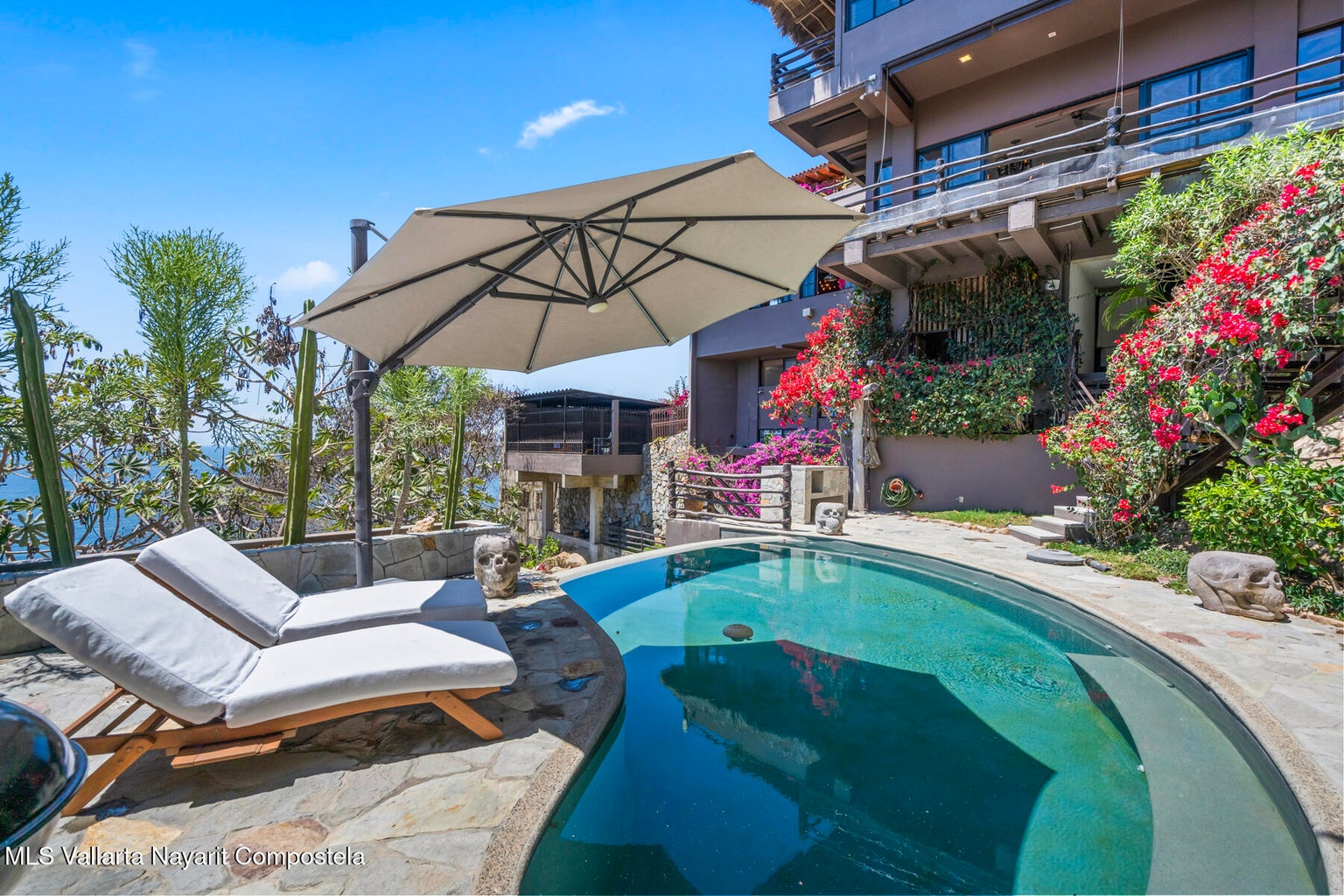 Luxury ocean view home for sale in Nanzal Hill, Sayulita featuring panoramic Pacific Ocean views, tropical landscaping, saltwater pool, rooftop terrace, gourmet kitchen, and elegant indoor-outdoor coastal living in Riviera Nayarit.