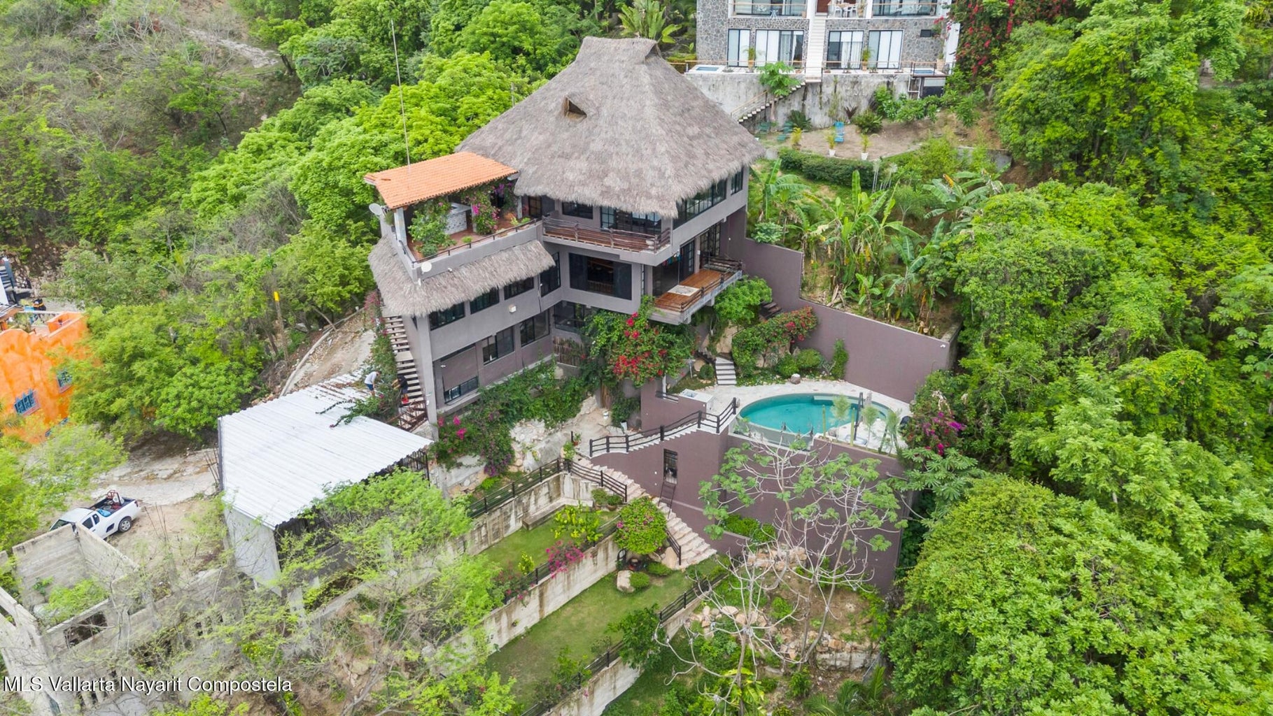 Luxury ocean view home for sale in Nanzal Hill, Sayulita featuring panoramic Pacific Ocean views, tropical landscaping, saltwater pool, rooftop terrace, gourmet kitchen, and elegant indoor-outdoor coastal living in Riviera Nayarit.
