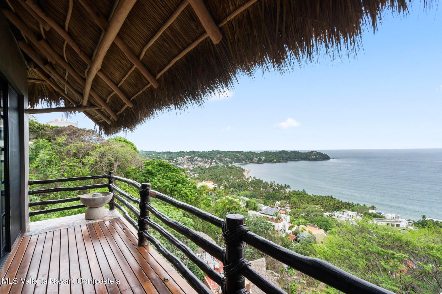 Luxury ocean view home for sale in Nanzal Hill, Sayulita featuring panoramic Pacific Ocean views, tropical landscaping, saltwater pool, rooftop terrace, gourmet kitchen, and elegant indoor-outdoor coastal living in Riviera Nayarit.
