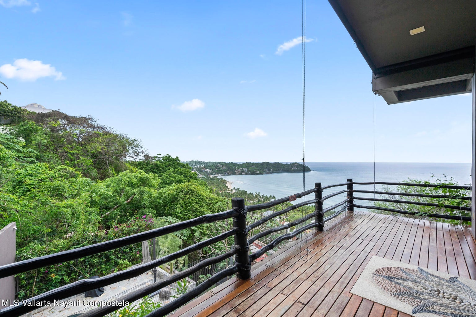 Luxury ocean view home for sale in Nanzal Hill, Sayulita featuring panoramic Pacific Ocean views, tropical landscaping, saltwater pool, rooftop terrace, gourmet kitchen, and elegant indoor-outdoor coastal living in Riviera Nayarit.