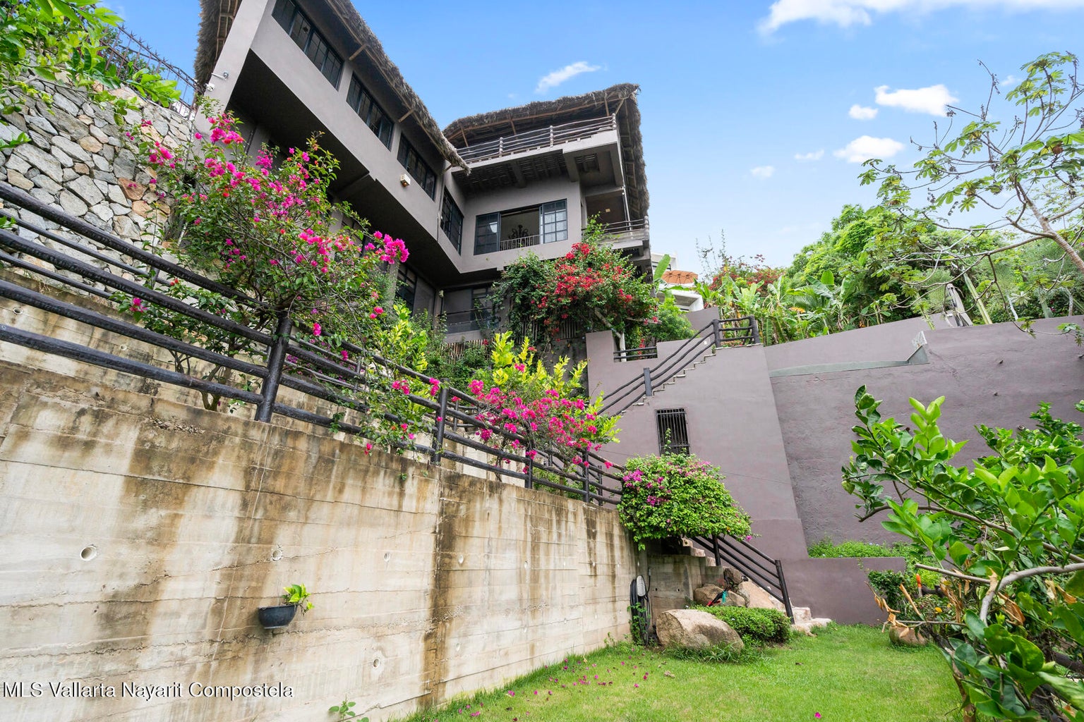 Luxury ocean view home for sale in Nanzal Hill, Sayulita featuring panoramic Pacific Ocean views, tropical landscaping, saltwater pool, rooftop terrace, gourmet kitchen, and elegant indoor-outdoor coastal living in Riviera Nayarit.