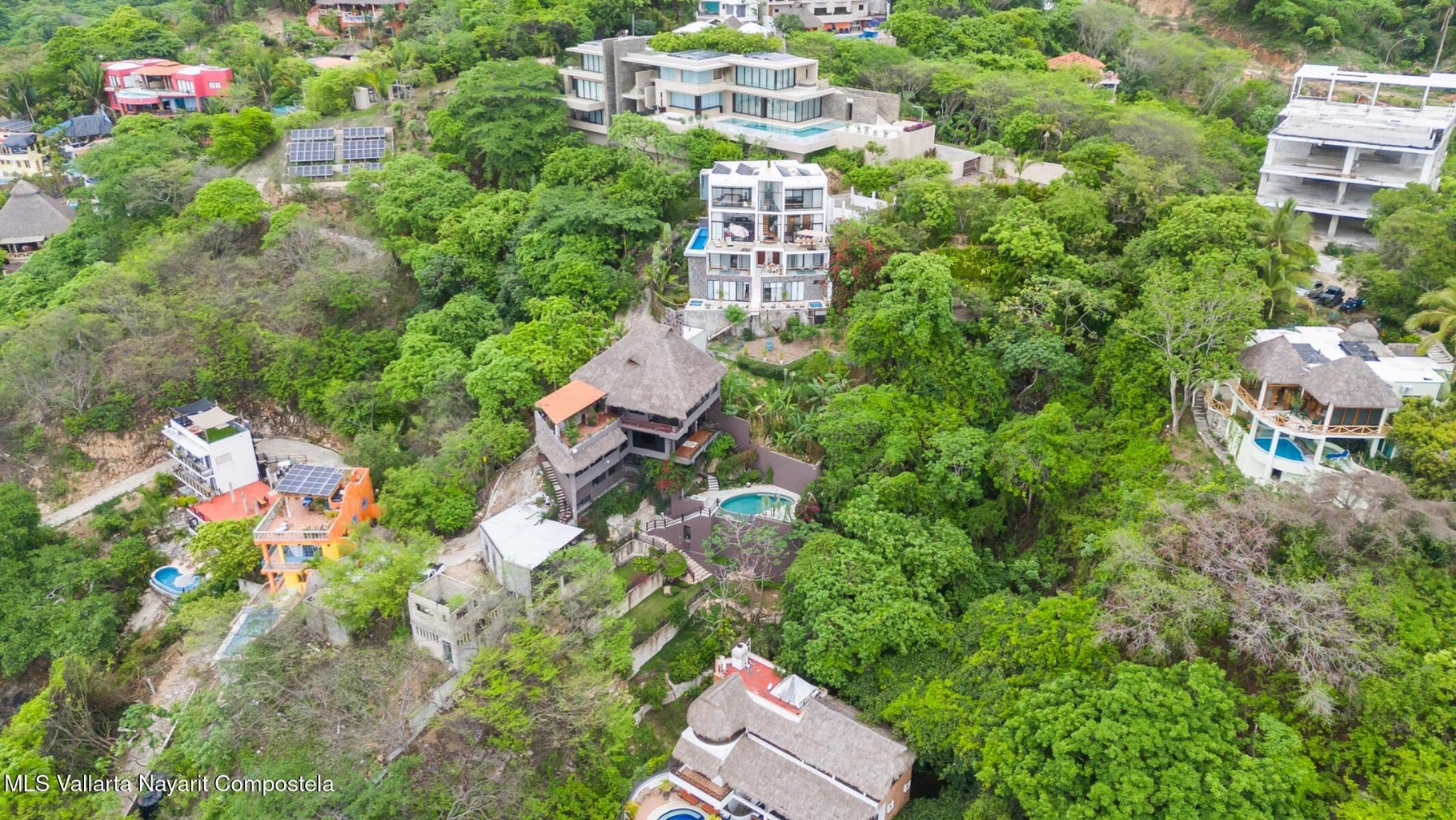 Luxury ocean view home for sale in Nanzal Hill, Sayulita featuring panoramic Pacific Ocean views, tropical landscaping, saltwater pool, rooftop terrace, gourmet kitchen, and elegant indoor-outdoor coastal living in Riviera Nayarit.