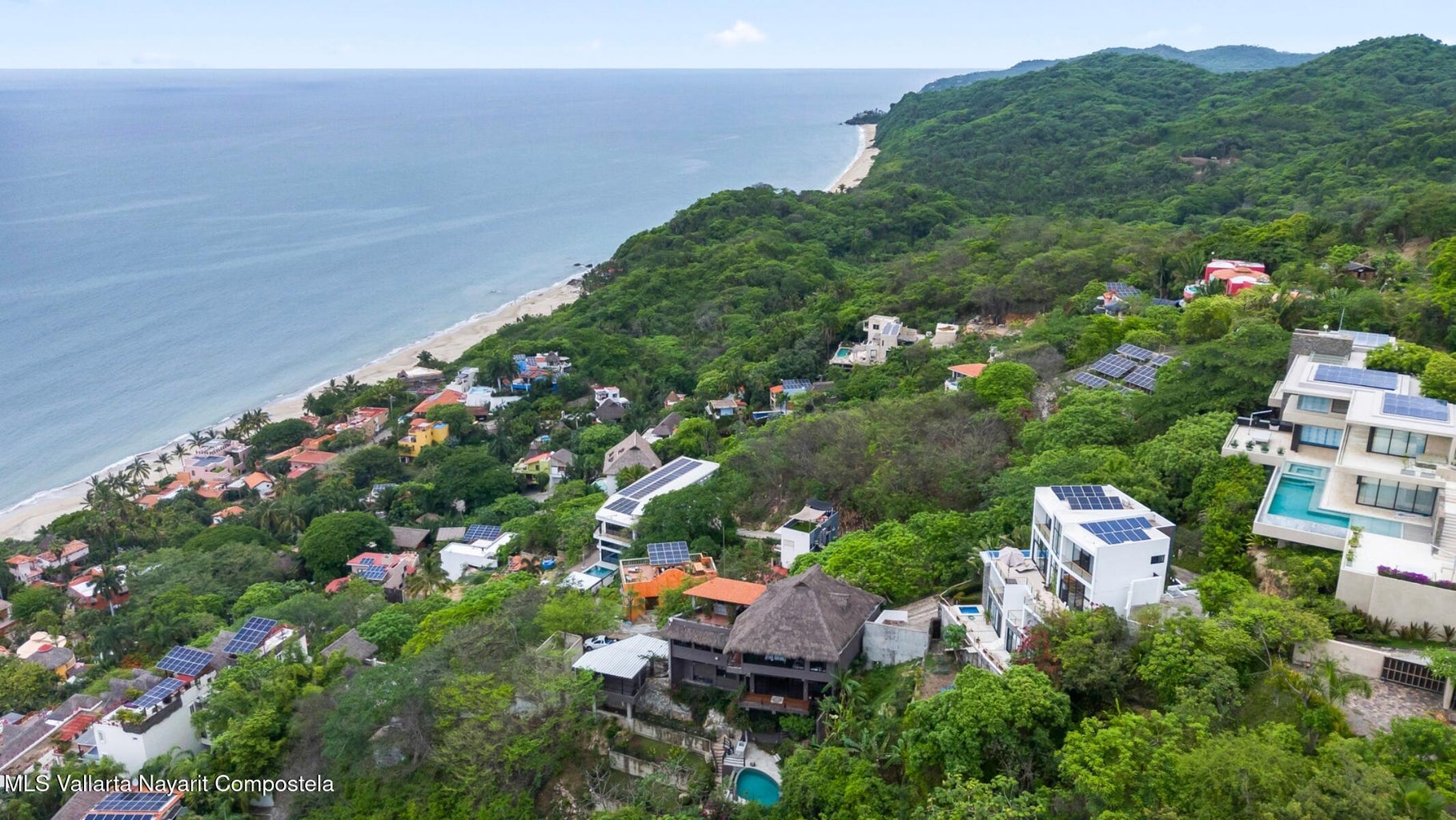 Luxury ocean view home for sale in Nanzal Hill, Sayulita featuring panoramic Pacific Ocean views, tropical landscaping, saltwater pool, rooftop terrace, gourmet kitchen, and elegant indoor-outdoor coastal living in Riviera Nayarit.