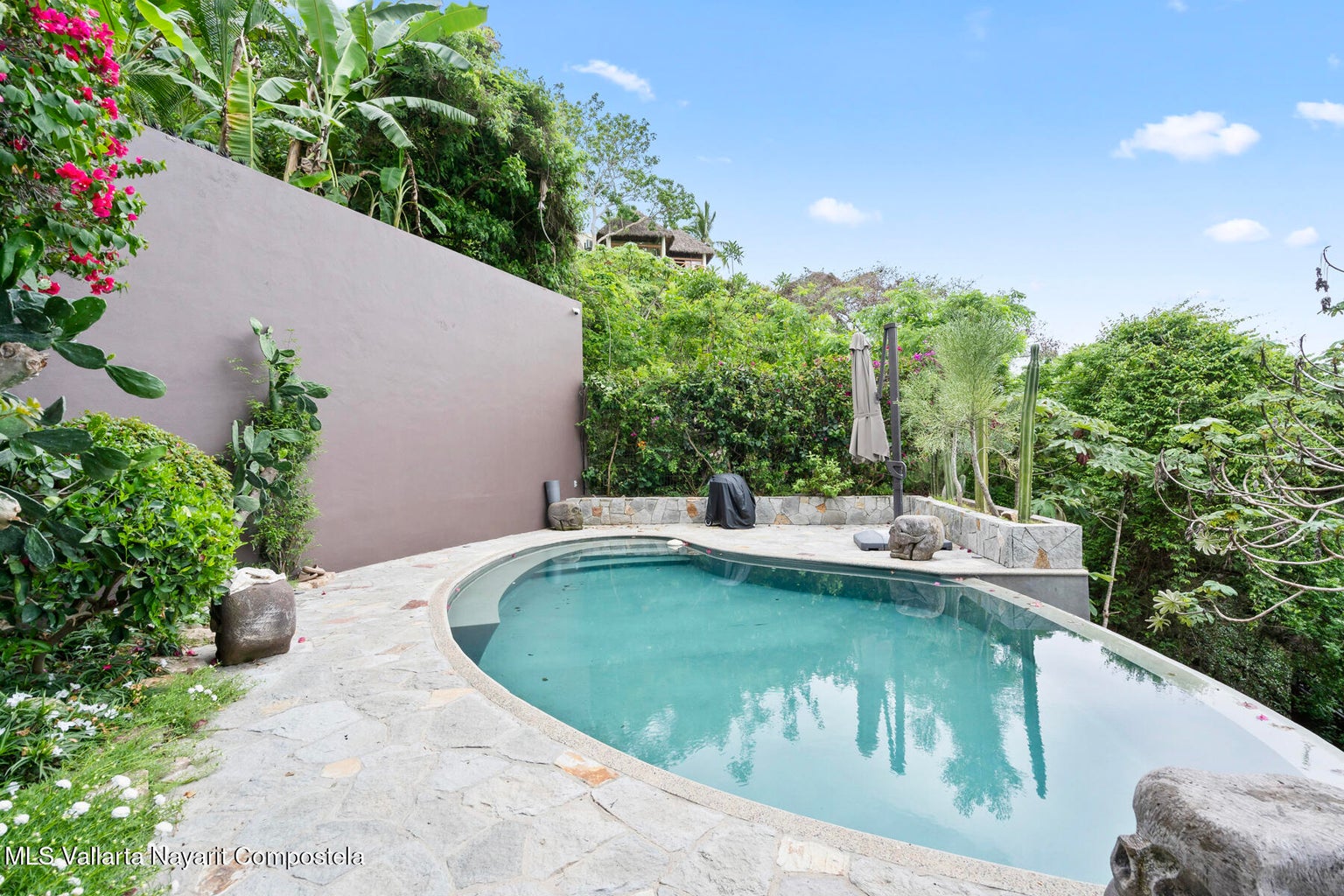 Luxury ocean view home for sale in Nanzal Hill, Sayulita featuring panoramic Pacific Ocean views, tropical landscaping, saltwater pool, rooftop terrace, gourmet kitchen, and elegant indoor-outdoor coastal living in Riviera Nayarit.