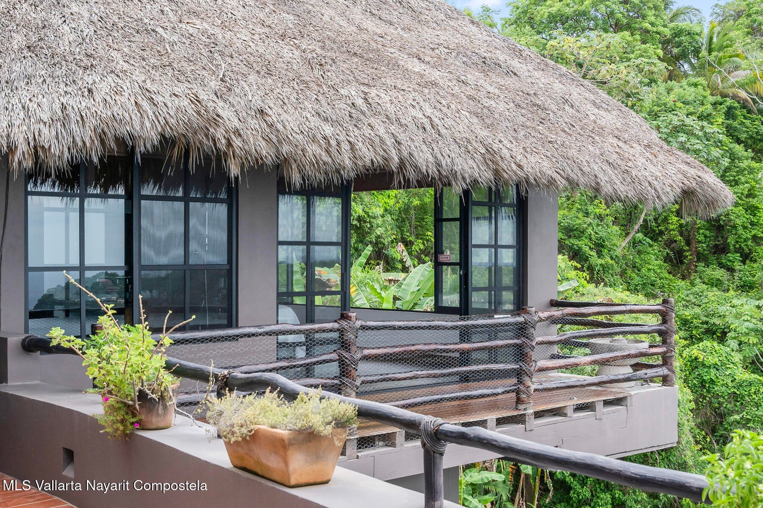 Luxury ocean view home for sale in Nanzal Hill, Sayulita featuring panoramic Pacific Ocean views, tropical landscaping, saltwater pool, rooftop terrace, gourmet kitchen, and elegant indoor-outdoor coastal living in Riviera Nayarit.