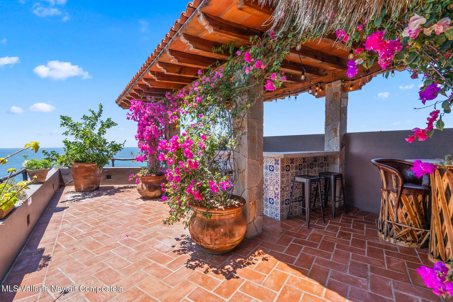 Luxury ocean view home for sale in Nanzal Hill, Sayulita featuring panoramic Pacific Ocean views, tropical landscaping, saltwater pool, rooftop terrace, gourmet kitchen, and elegant indoor-outdoor coastal living in Riviera Nayarit.